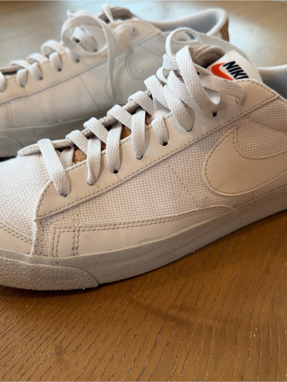 Nike White Low-Top Sneakers with Orange Swoosh Accent